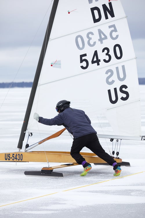 An iceboat racer pushes off at the start of a race during the 2021 IDNYIRA Nationals.
