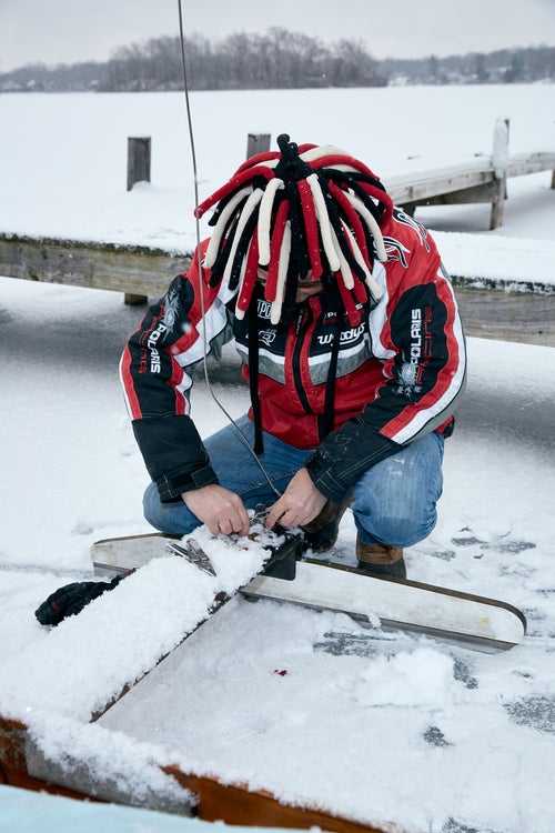 An iceboat racer secures a runner to the plank.