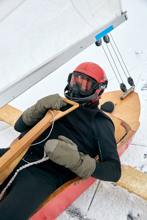 An iceboat racer demonstrates the utility of his mothguard. During collisions, the rudder can get pushed into the racer's mouth.