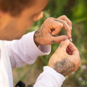 Joey Santore examines an Asclepias prostrata flower.