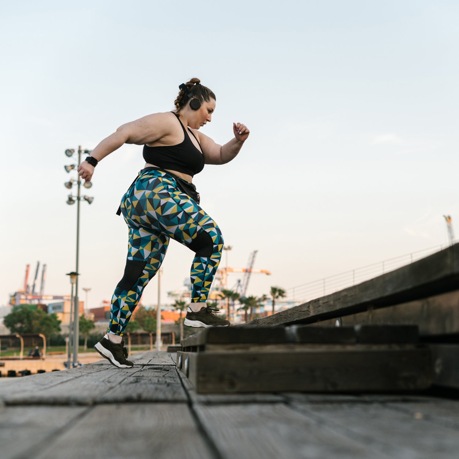 woman in sportswear climbing steps