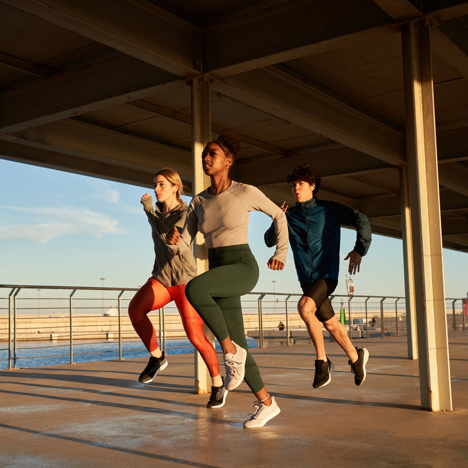 Three runners jogging at seaside