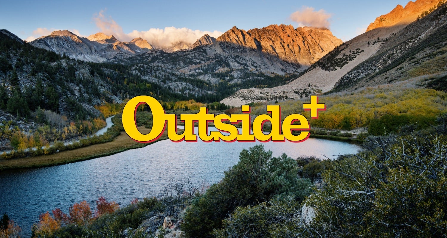 Outside+ logo over mountain lake