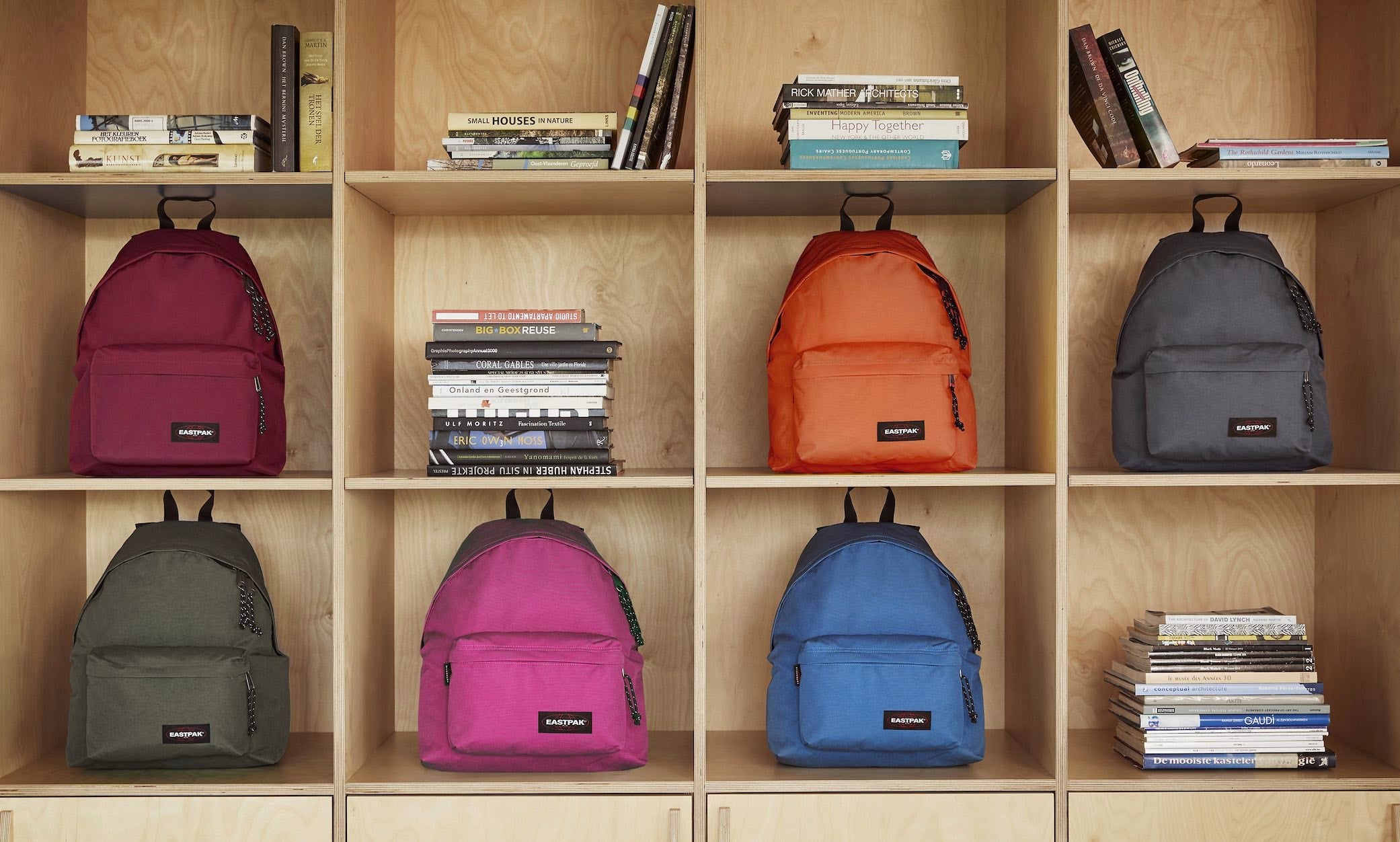 Eastpak backpacks on a bookshelf