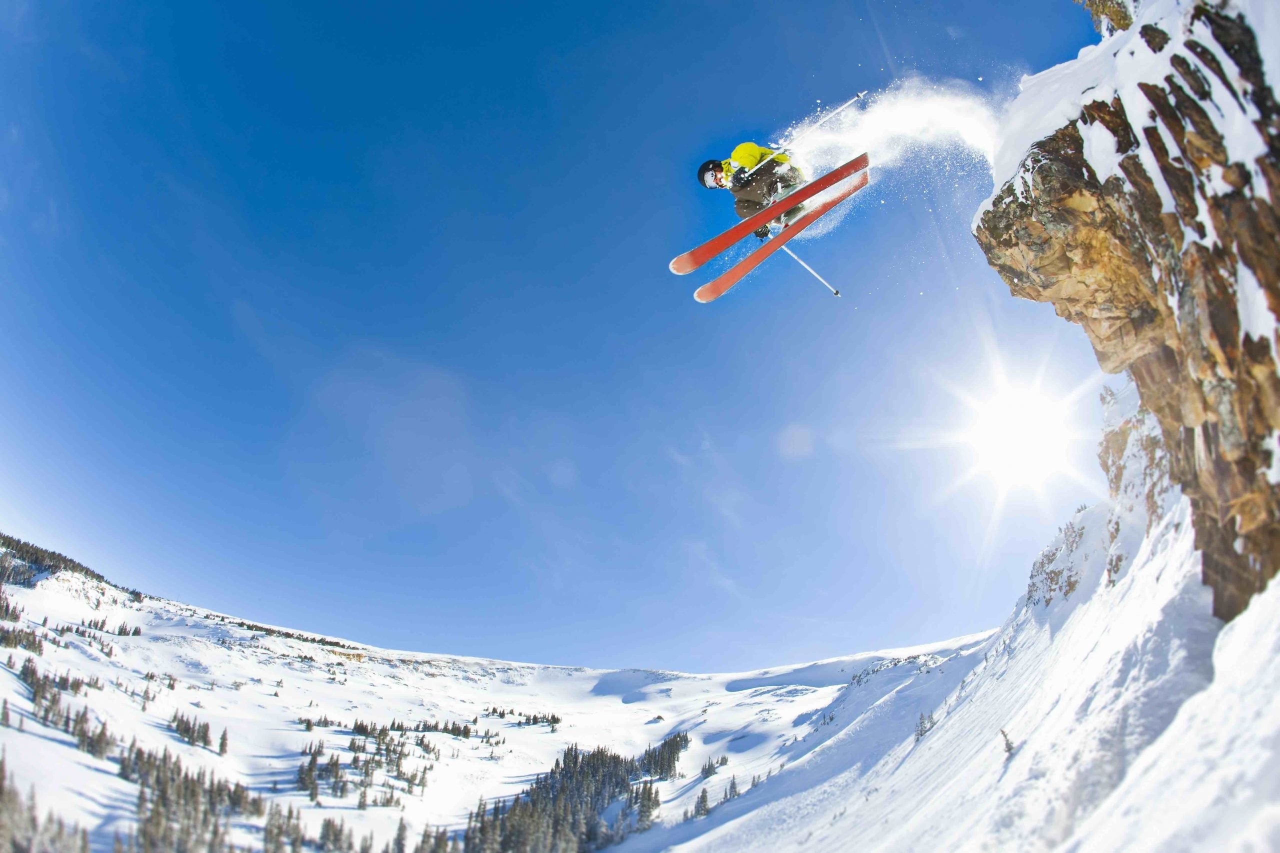 Freestyle skier jumping off cliff