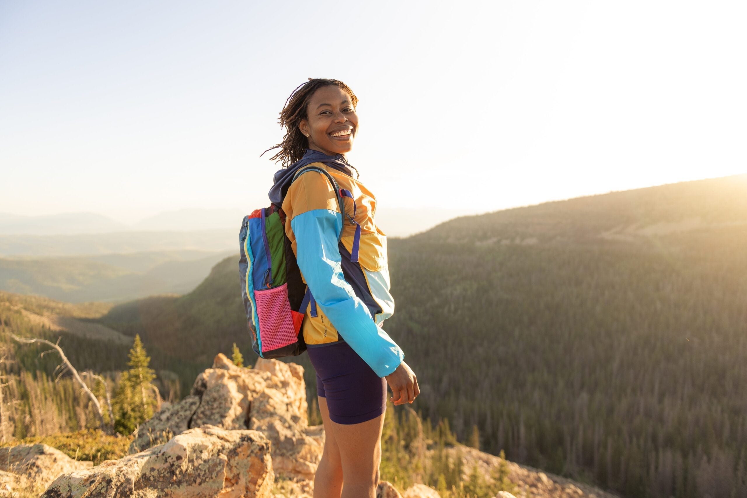 BIPOC woman standing on mountain top