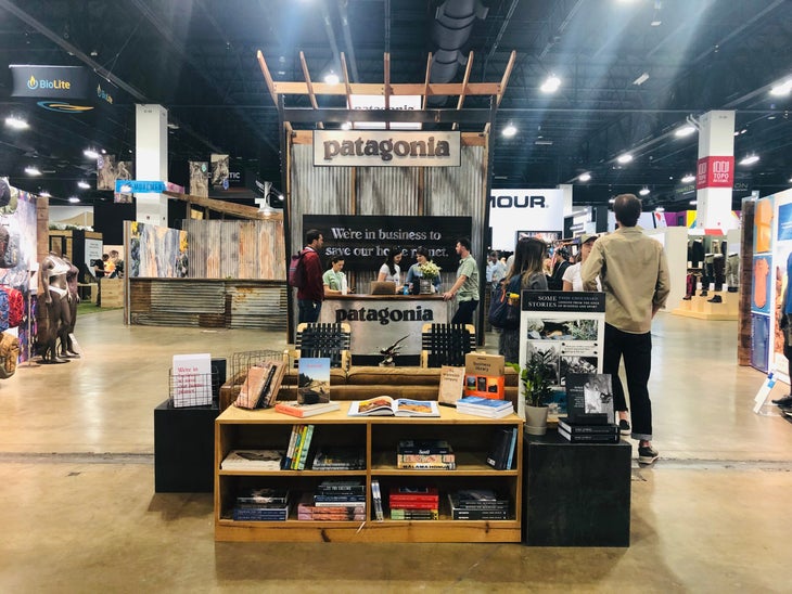 IMG_7867 Patagonia booth at Outdoor Retailer with shelves of books, corrugated metal