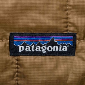 Patagonia logo close-up on a brown jacket