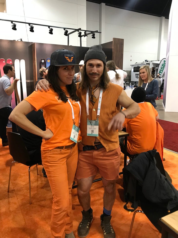 maro lablance op ed orange Maro LaBlance and man posing in a booth at Outdoor Retailer wearing orange.