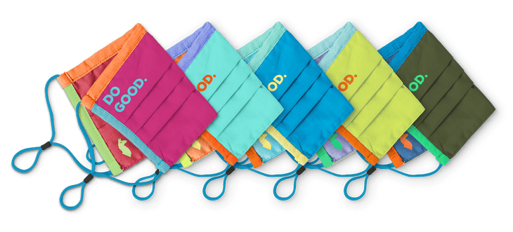 "Four colorful face masks lined up and folded on white surface. DO GOOD lettering on each mask"