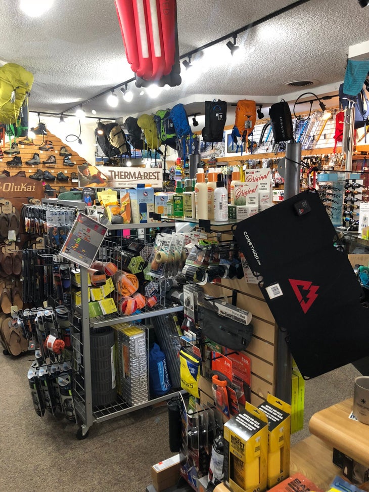Nomad Ventures Escondido Gear hangs from the ceiling at Nomad Ventures' Escondido location