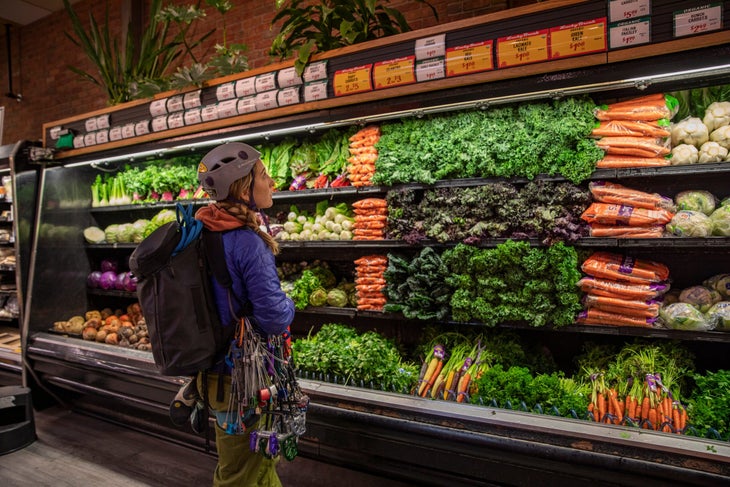 TheVoice_Winter2019_Albanese_0328 blonde woman in climbing gear shopping at the grocery store