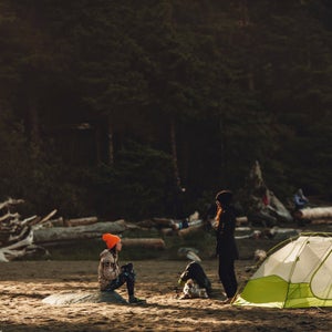 Two friends talking near a tent