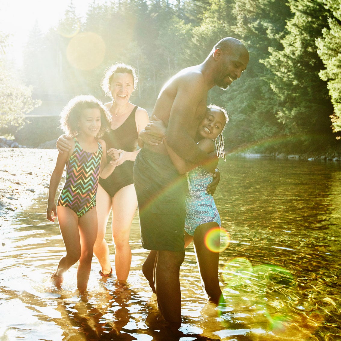 Kids laughing in a river.