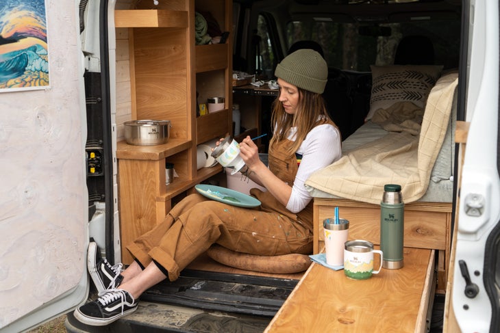 Gianna Andrews paints her coffee gear.