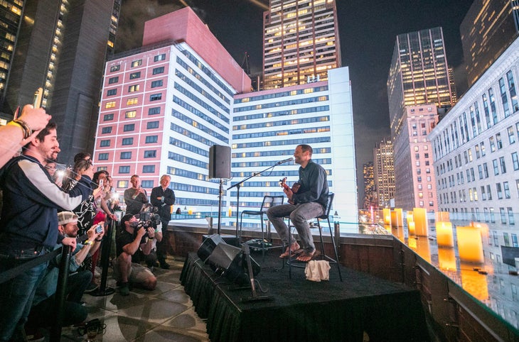 Musician Jack Johnson performing a private concert on a rooftop in New York City