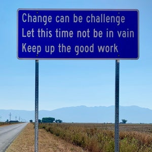 A sign next to a road