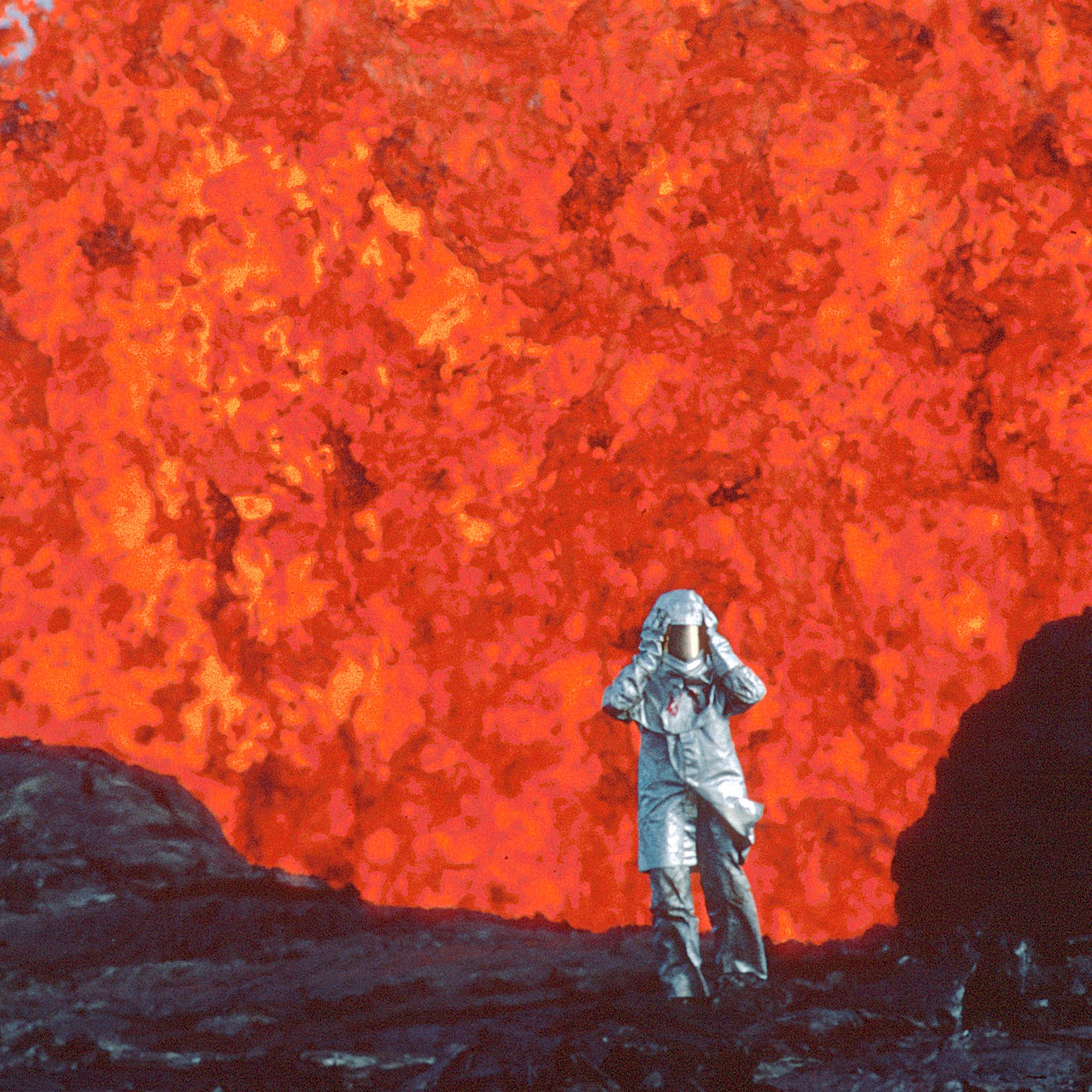 Person in suit in front of volcano
