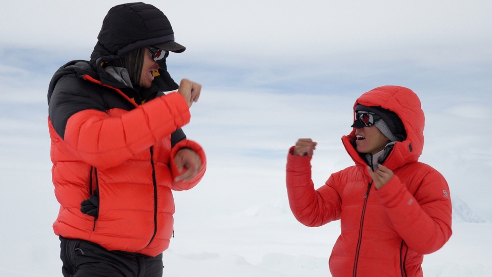 Scott Lehmann and Shayna Unger converse in ASL on a snow covered mountain