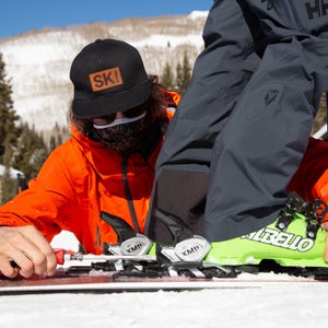 Ski tech adjusting binding to ski boot