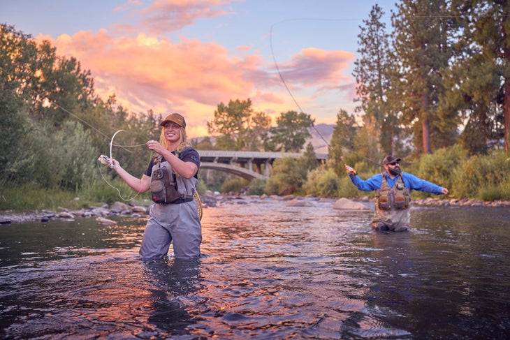 Two people fly fishing in the sierras during fall