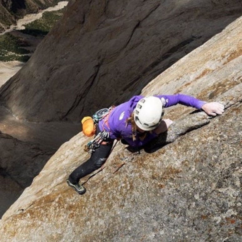 Climber high on a granite wall.