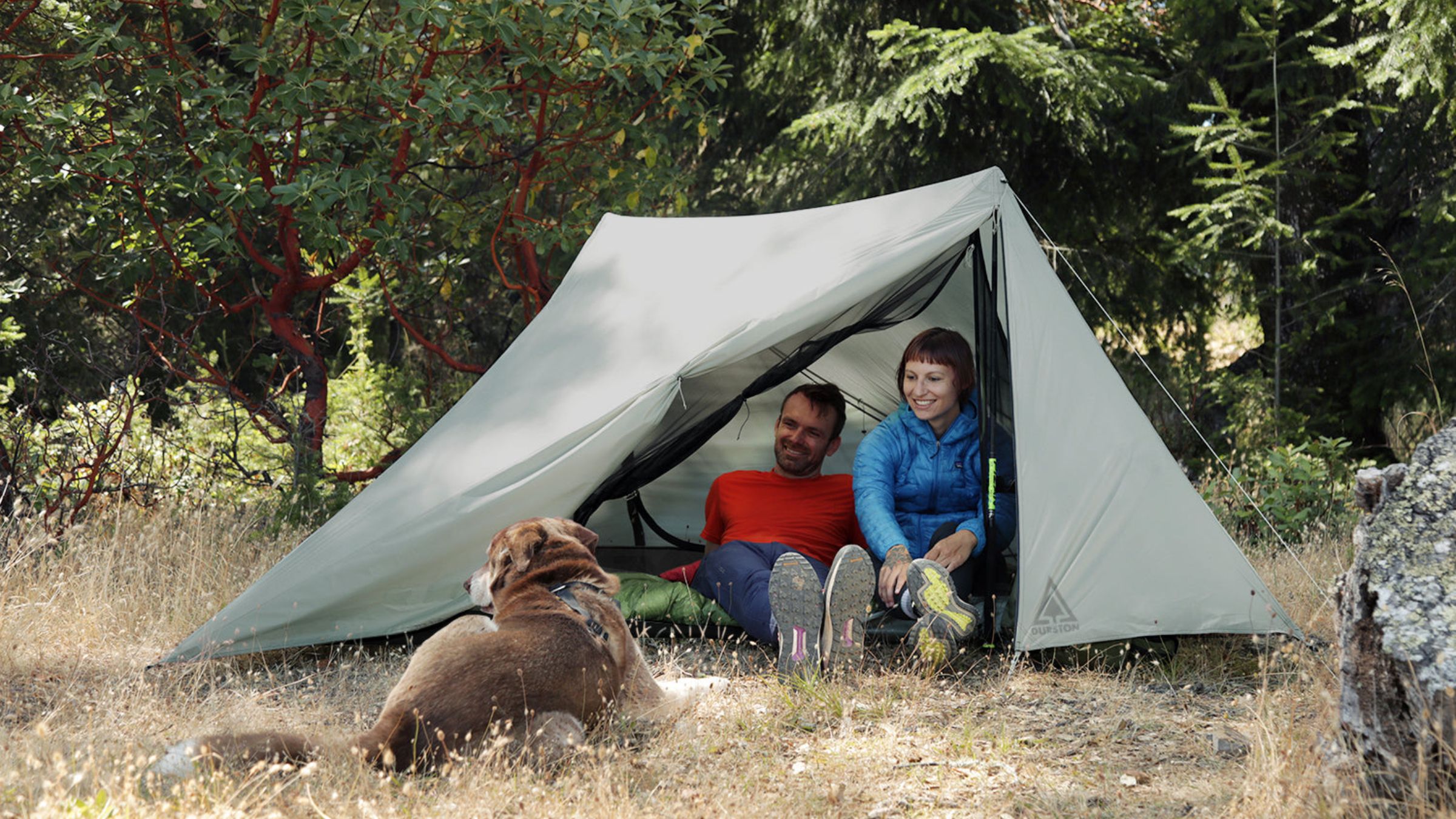 Two people sitting in an ultralight tent