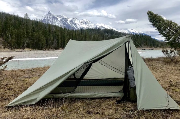 Green tent in a field