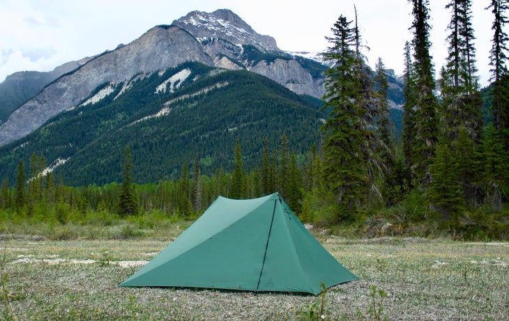 Green tent set up in a field