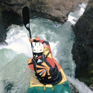 Man kayaks down a waterfall