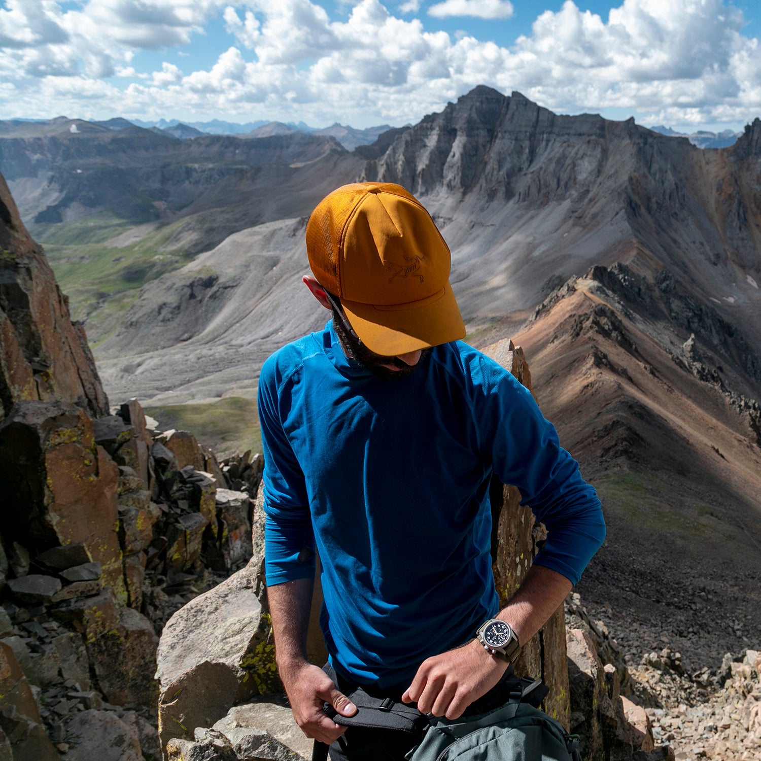 A climber checks their watch on a Colorado peak