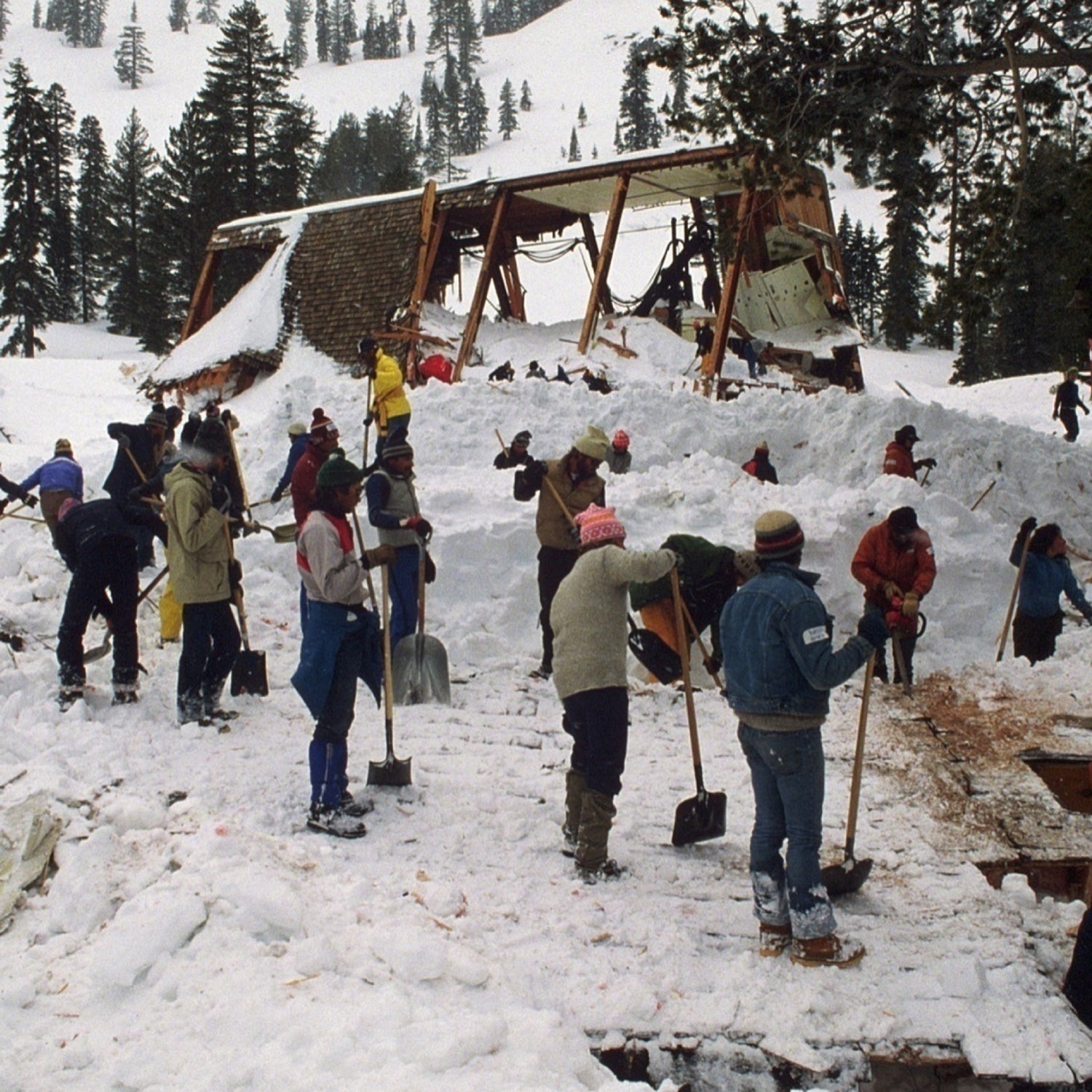 People searching through avalanche debris