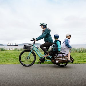 family biking on a large electric powered cargo bicycle