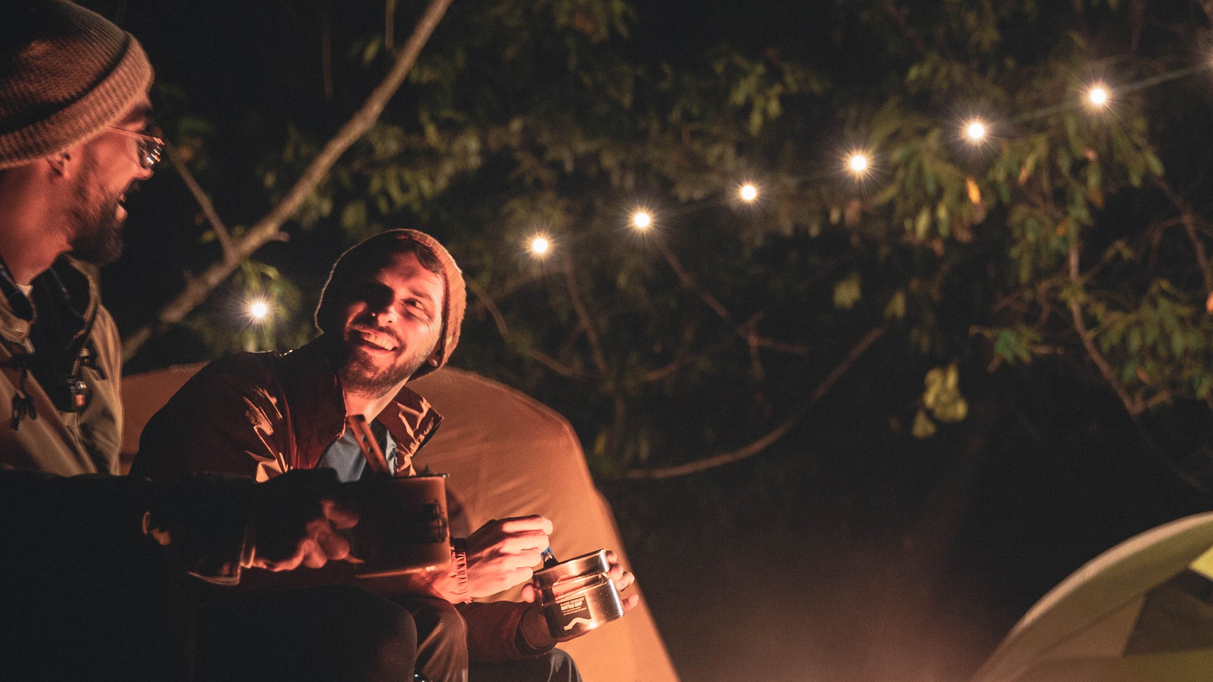 two people with lights camping