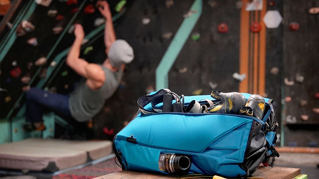 Mystery Ranch backpack in a climbing gym