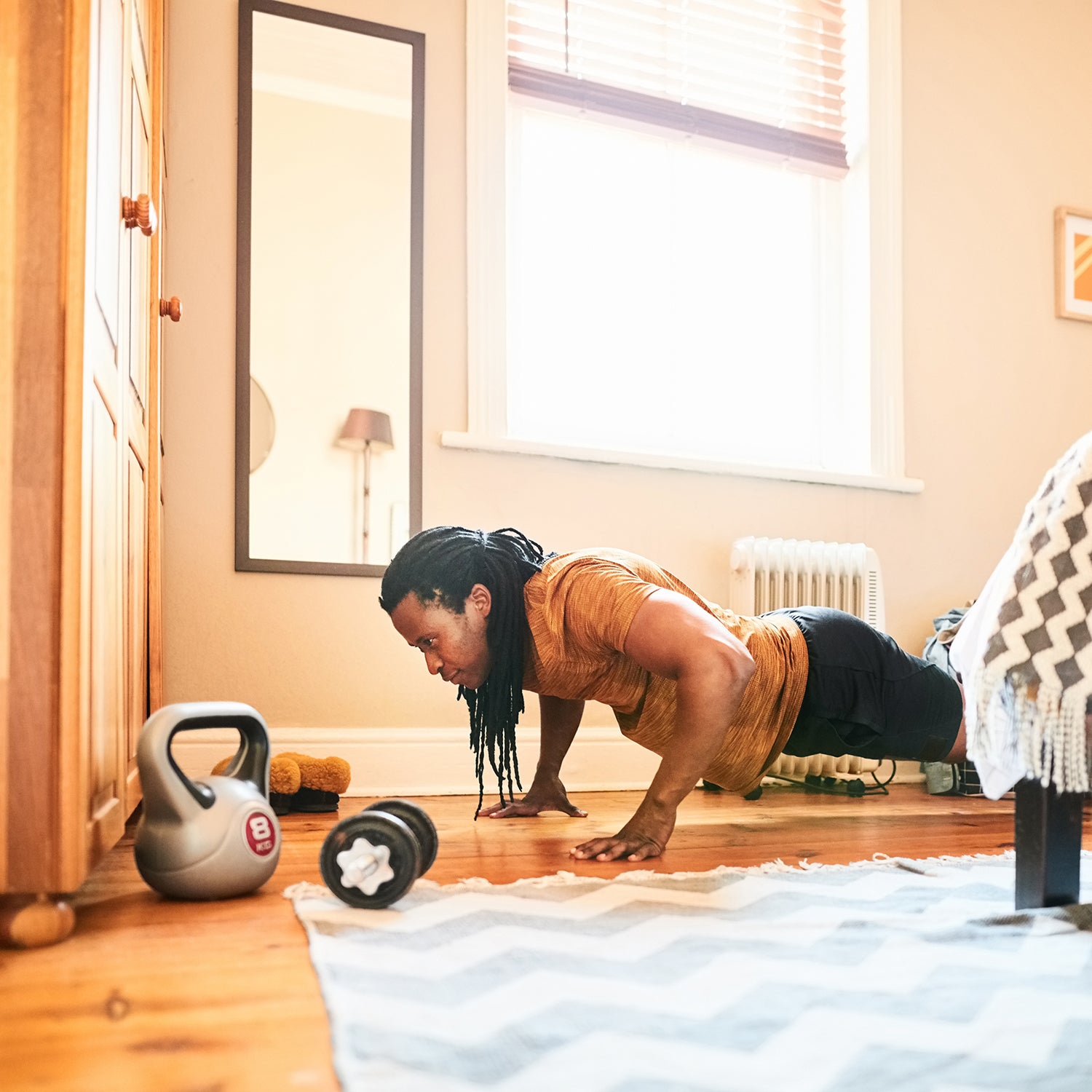Shot of a muscular man doing push ups at home