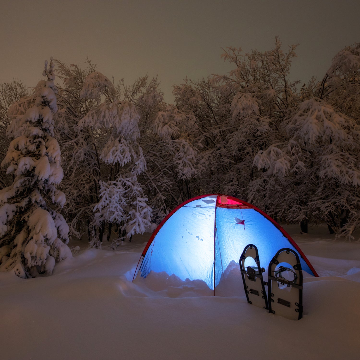 Glowing winter tent at night