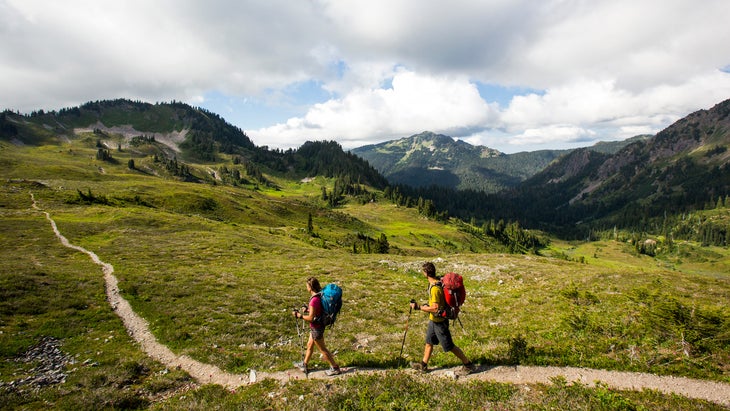 man and woman hiking trail