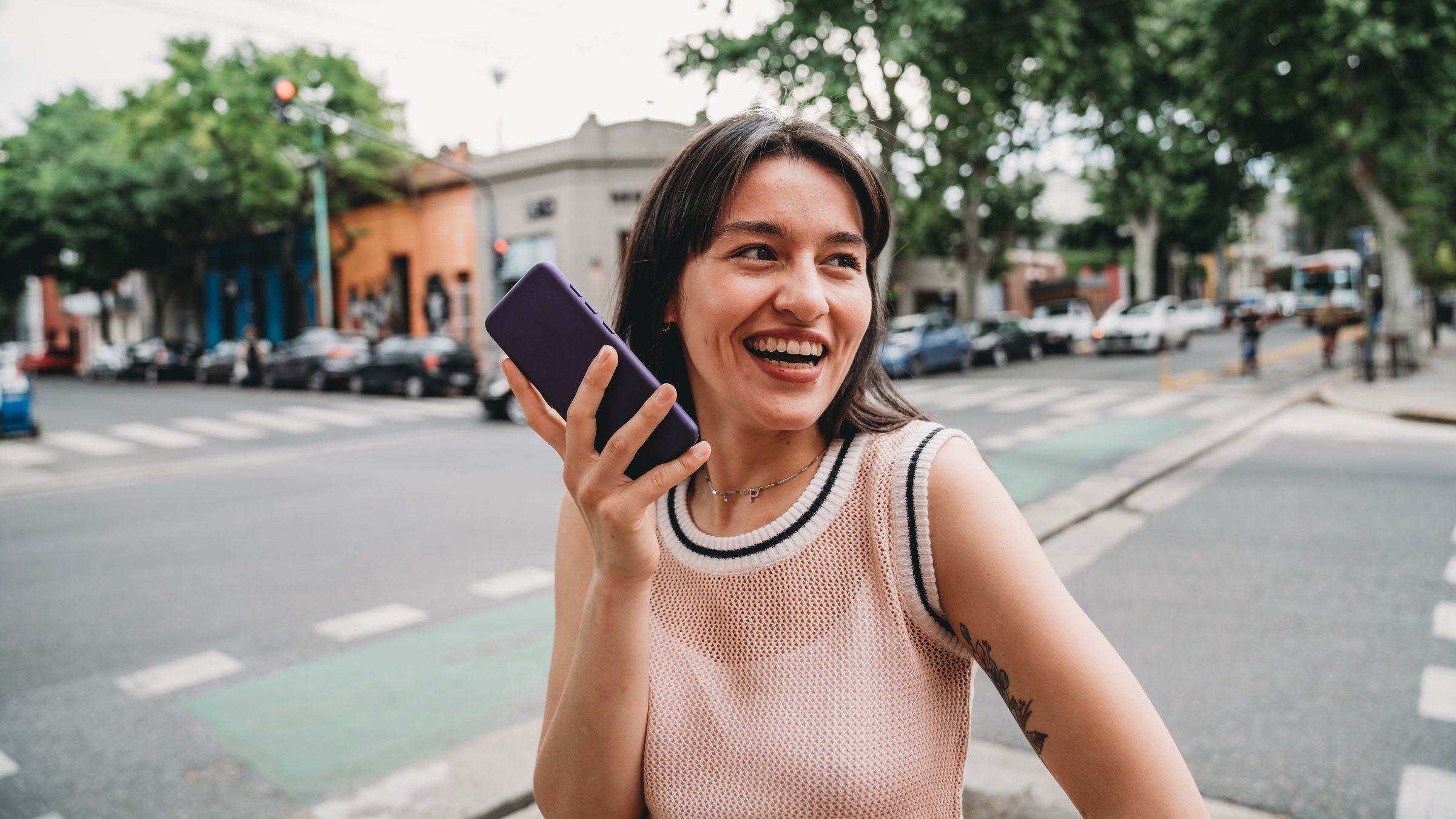 Woman records herself on her phone while walking outside