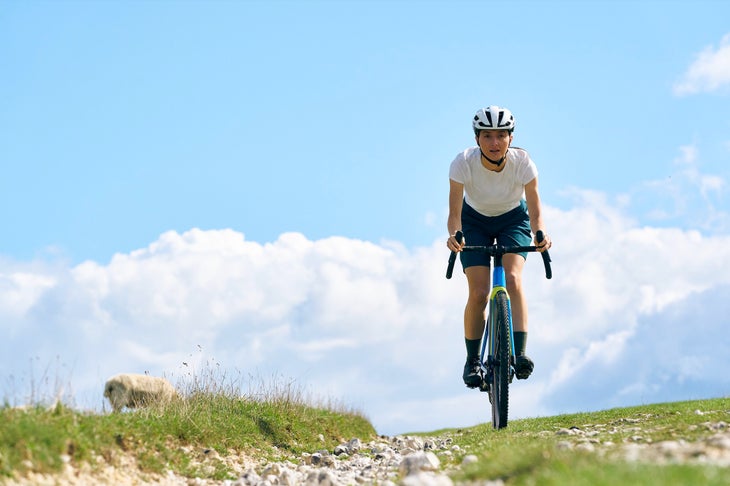 Woman riding bike in field