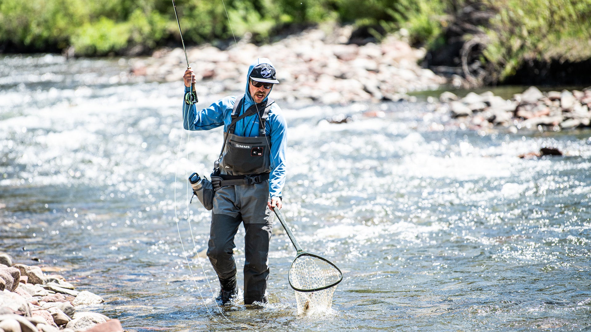 man fly fishing with Simms gear