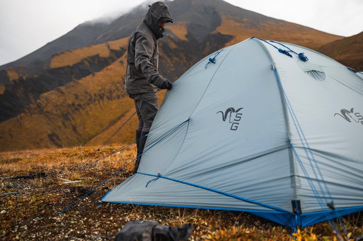 Man with tent in the mountains