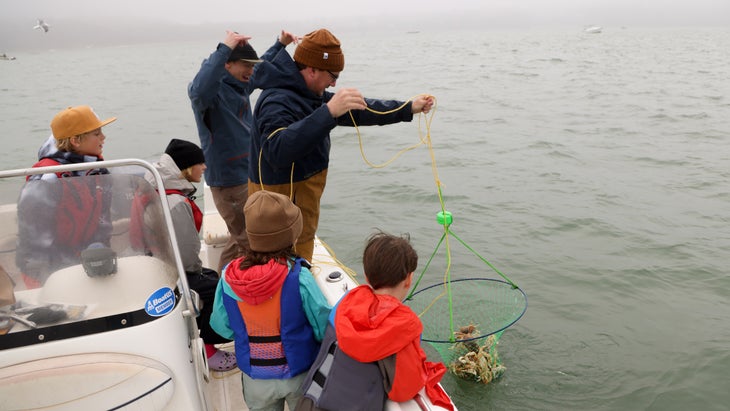 The author's family and friends admire their crab catch.