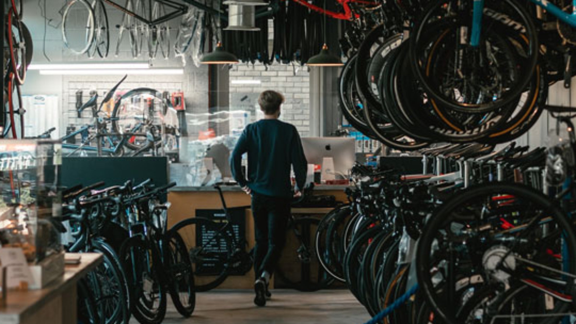man walking through bike shop