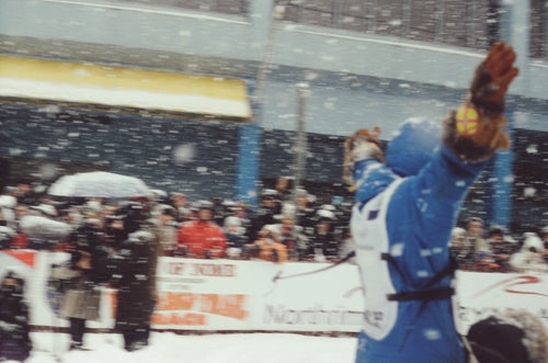 A snowy scene at the start of a sled-dog race