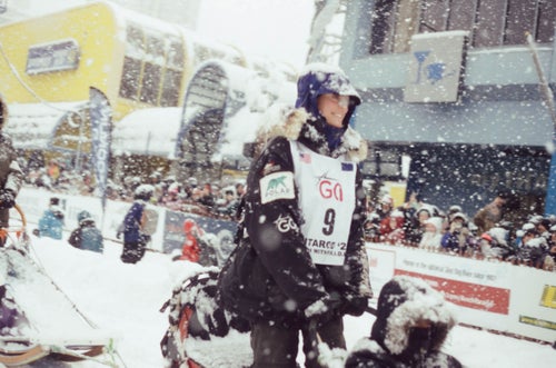 A woman at the start of a dog sled race