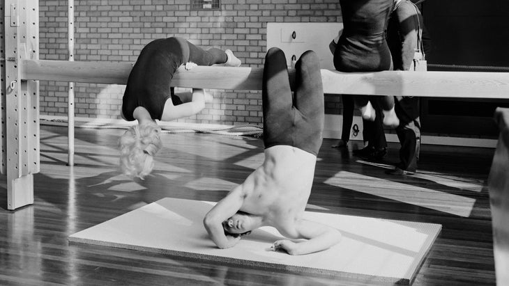 Vintage black and white photo of a gymnastics class with gym equipment