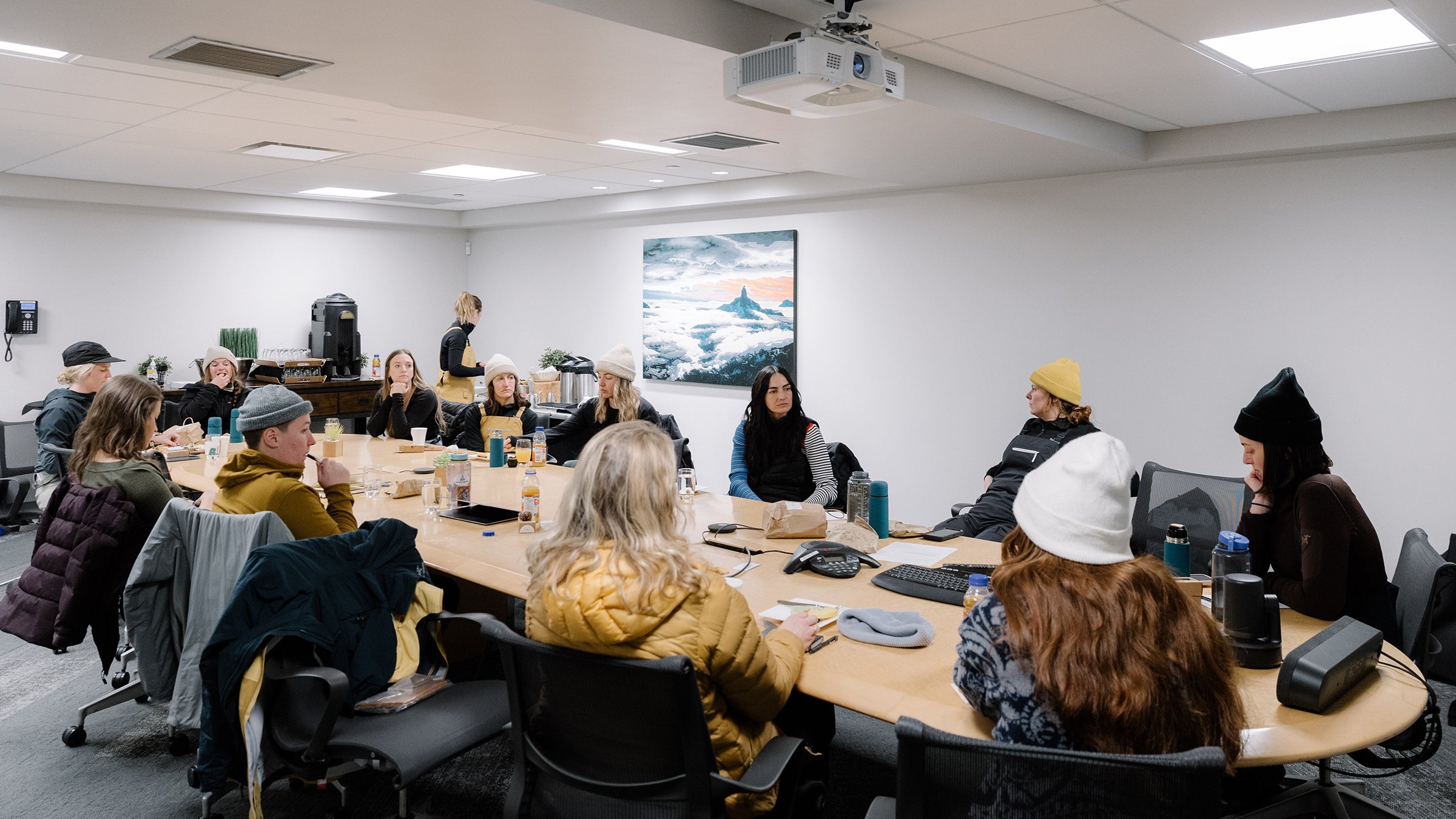 Women from Arc’teryx sitting around a conference room table