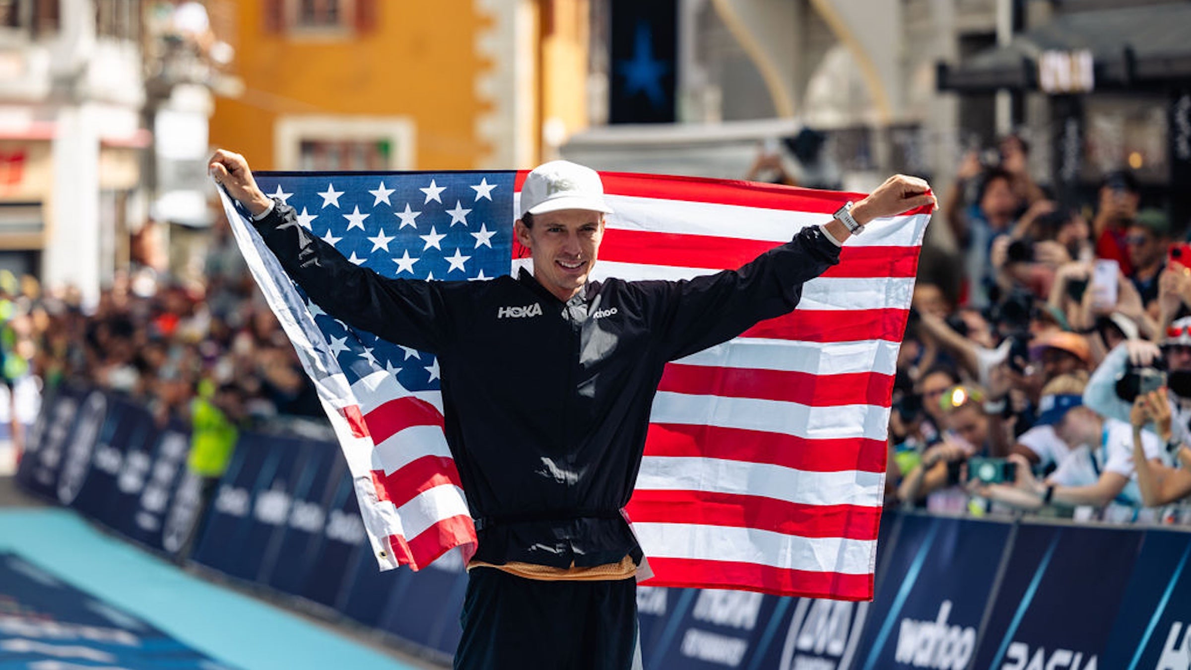 walmsley holds up american flag after winning UTMB