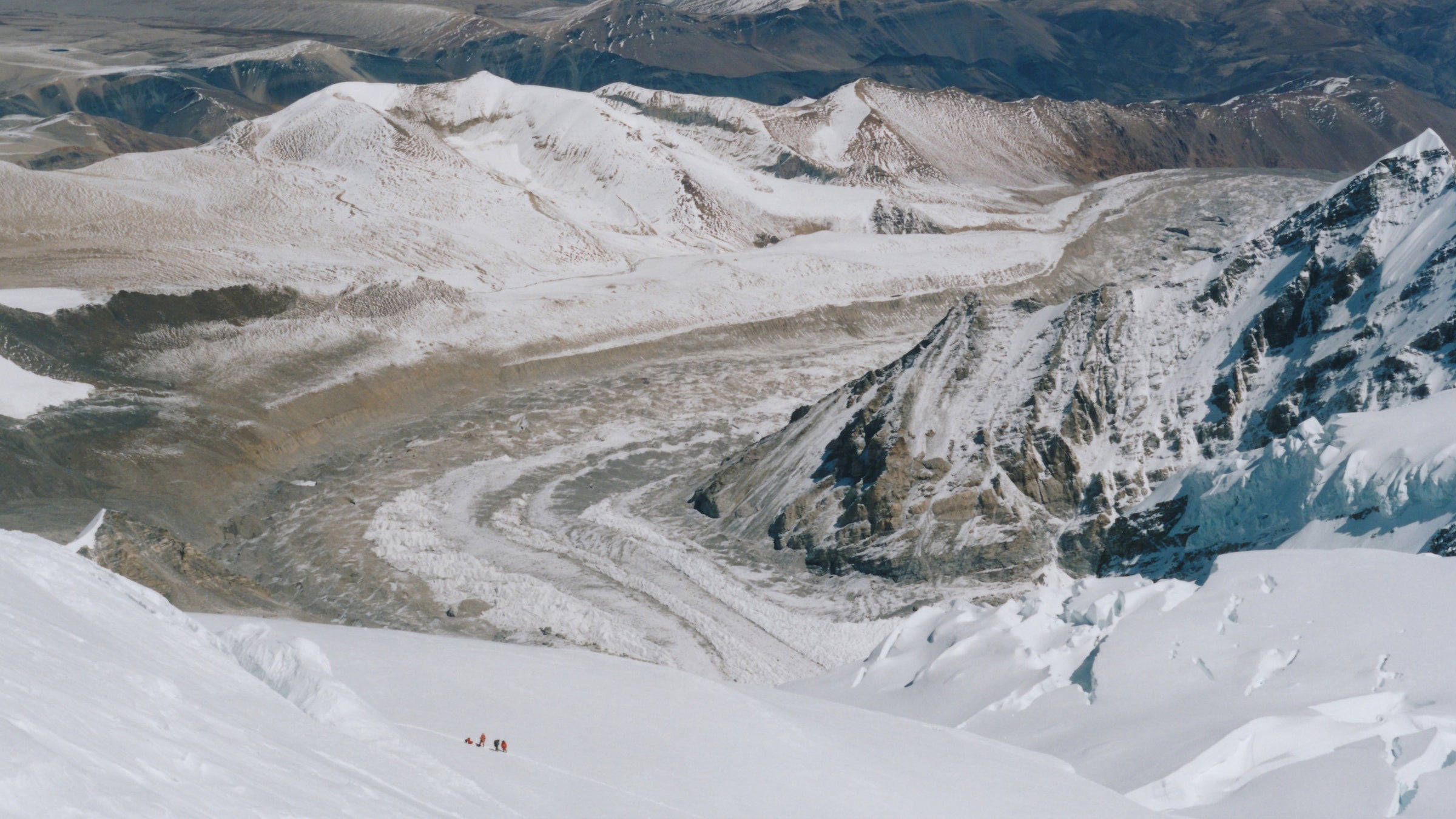 A group of rescuers respond to an avalanche on the side of a mountain